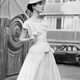 (Original Caption) Attention: Women's Page Editor. Paris, France: "Orlon" fiber adapted to silks and satins and the heavier weight of wool is being featured in the current spring-summer Paris fashion collections. Here are two fashions in the orlon fabric. At left, a Jean Desses two-piece dress in chalk white shantung or orlon-acrylic fiber and silk. This crisp yet supple fabric is lightweight and soft and its pleats are durable. At right: Jean Patou's new collection includes this new-length coat in white flannel of orlon-acrylic fiber and wool. It is soft to the touch, yet warm and lightweight. February 17, 1955.
